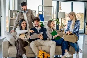 Group of diverse young adults are studying and collaborating together, using a digital tablet for their university project