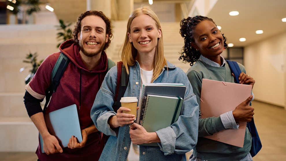 Multiracial group of happy college friends looking at camera.