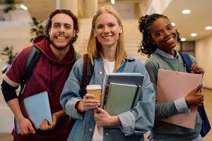 Multiracial group of happy college friends looking at camera.